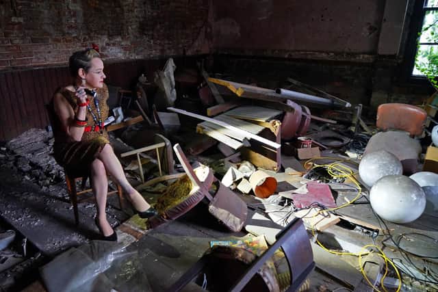 Rebecca Hurd surveys the debris in the upstairs room which has been neglected for decades.