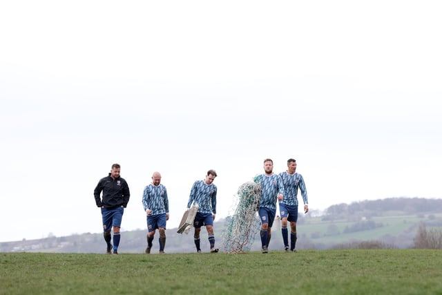 The players walk back with the goal net after the Chesterfield and District Sunday Football League HKL Division Two match between Hepthorne Lane and FC Spotted Frog.