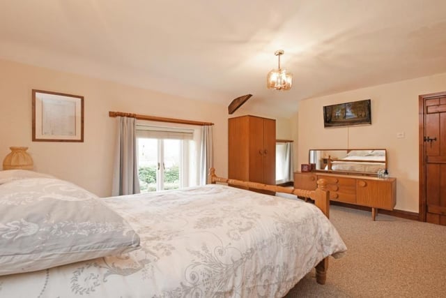 The master bedroom looks out over the front of the house which has far-reaching views.