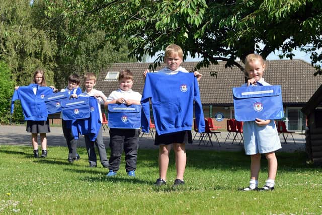 Walton Peak Flying High Academy pupils showing off the new uniform and book bags