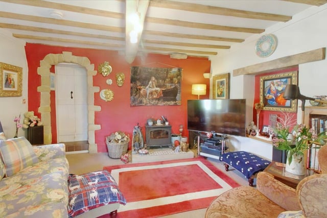 This characterful room has a multi-fuel log burner set on a stone hearth.