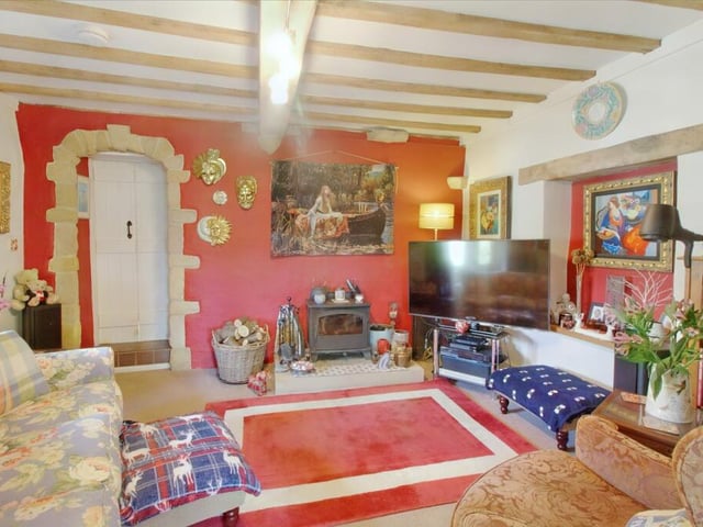 This characterful room has a multi-fuel log burner set on a stone hearth.