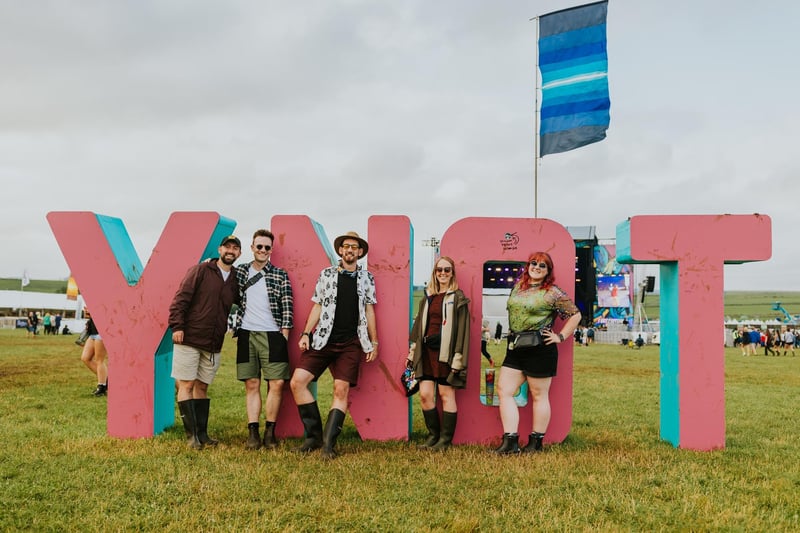 Festival fans pose at the iconic sign.