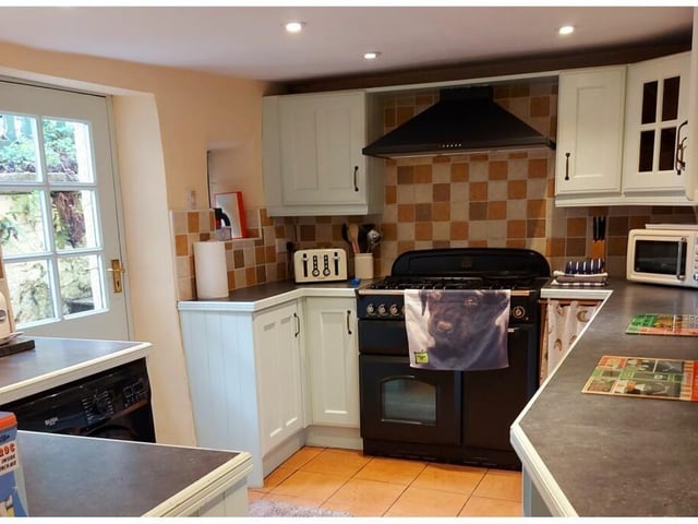 The kitchen has a gas/electric range, integrated fridge and freezer, dishwasher and washing machine. There is understairs storage.