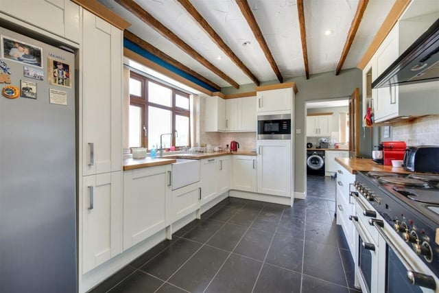 The breakfast kitchen is fitted with base and wall units with contrasting wood block effect work surfaces. Integrated appliances include a fridge, microwave and dishwasher, together with freestanding range cooker.