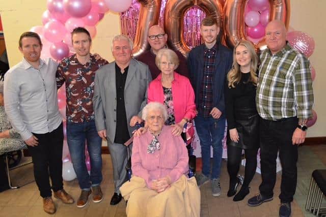 Margaret with her family at her 100th birthday party in St Barnabas Church Hall. pictured from the left is Mark Woods (grandson), Carl Woods (grandson), Steve Woods (son), Anthony (Jack) Lindley (grandson), Margaret, Jenny (Jen)  Lindley (daughter), Lewis Lindley (great-grandson),  Abbie Lindley (great-granddaughter), Andy Lindley (grandson)