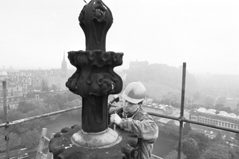 Stone mason Jimmy Gilfillan works on the restoration of the stonework at the very top of the Scott Monument in Edinburgh, October 1988.