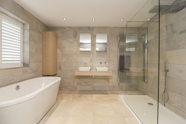 The ground-floor master bedroom ensuite contains Jack and Jill wash basins, a bath and a separate shower cubicle and is one of two bathrooms in the property.