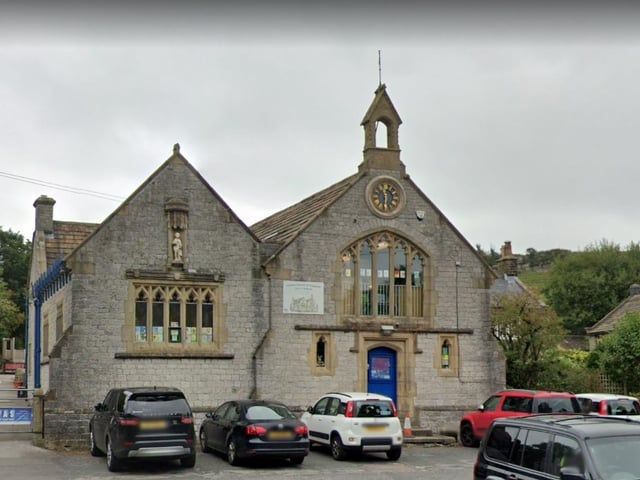 The school house was built around 1869. This regal-looking building features mullioned windows, and a niche containing a statue.