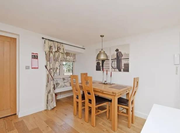 There is ample space for a dining table and chairs and a built in seating area beneath the side facing window.