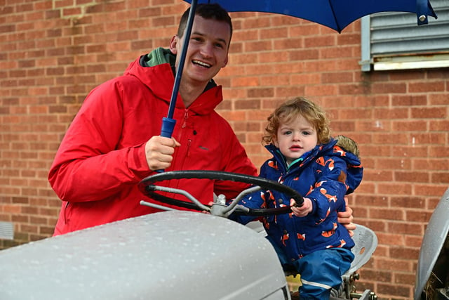 No chance of this little one's enthusiasm for tractors being dampened by a shower of rain.