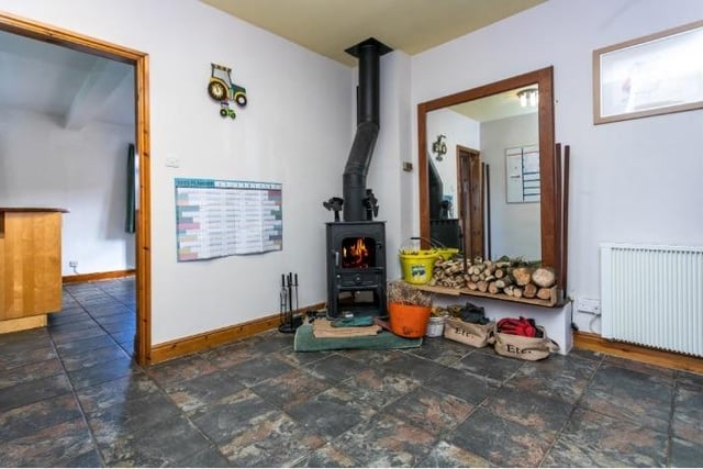 The large entrance hall contains a log burner.