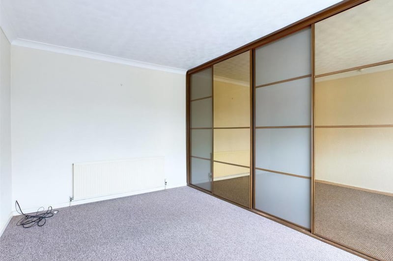 Maser bedroom with a range of fitted wardrobes