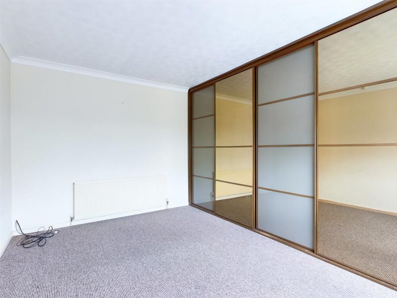 Maser bedroom with a range of fitted wardrobes