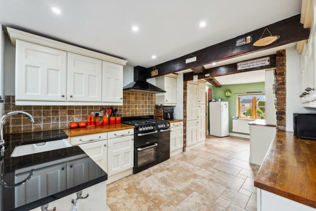 The extended kitchen diner is located in the centre of the house. Fitted units are complemented by a range oven, butcher block worktops and Belfast sink.