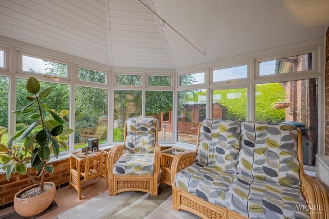 The colourful conservatory is a relaxing space that offers lovely views of, and access to, the garden.
