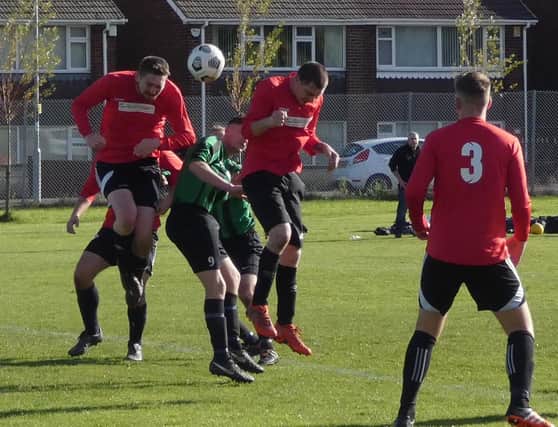 Action from Sunday's HKL 3 game which saw Bridge Inn [red]  beat Hollingwood Ath  7-3. Pic by Martin Roberts.