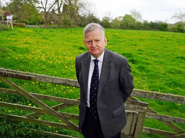 Coun Martin Thacker next to Hipper Hall in Holymoorside, near Chesterfield, where a strip of land is for sale.