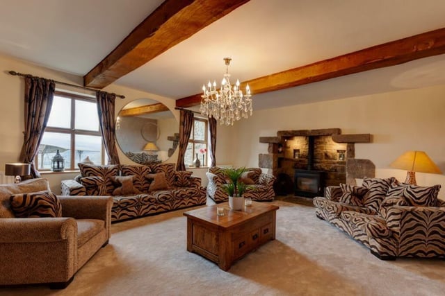 The impressive lounge has eye-catching exposed ceiling beams and a log burning stove housed in an inglenook stone fireplace.