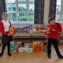 Head Girl and Head Boy at Horsley Woodhouse Primary School with the donations they collected for local charity, Salcare.