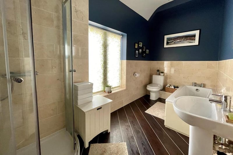 Four-piece bathroom with bath, wash hand basin, shower enclosure and low level WC.