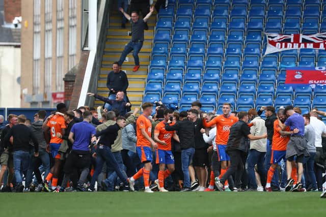 Oldham Athletic fans invaded the pitch after scoring late on against Chesterfield. Picture: Tina Jenner.