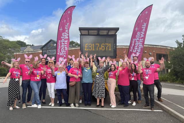 Staff at Ashgate Hospice celebrate the amazing amount of money donated by participants on this year's Sparkle Night Walk.