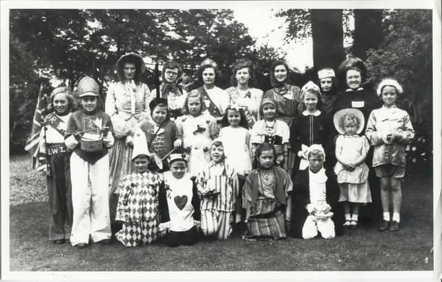 Fancy dress has always been a big part of Carnival day. This is a group of children fro the villager dressed in fancy dress for carnival day, pictured in the grounds of Winster Manor, c.1945. The villagers are named on the reverse of the photograph and will be recorded in the archive. (Photo: Winster History Group/WCWCA)