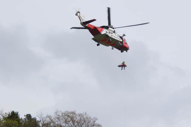 The Coastguard hovering in stormy weather around High Tor. Photo : Peter Reed.