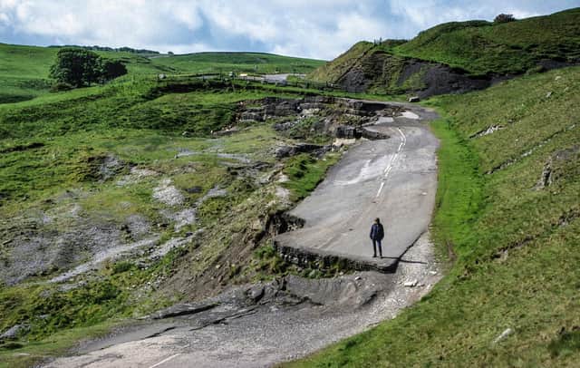 The old main road west of Castleton, closed since 1977, where walkers can now see the dramatic effects of the landslide that continues to move when saturated by rainfall every winter (photo by Tony Waltham Geophotos).