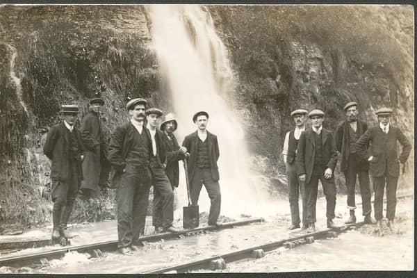 Floodwater gushing down onto the railway track at Bolsover didn't stop these men from having their photo taken before the First World War.