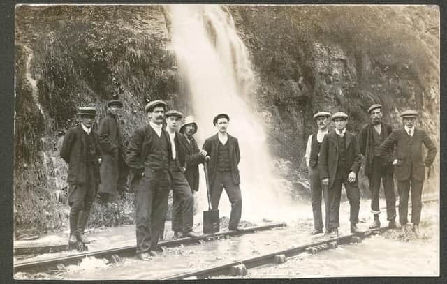 Floodwater gushing down onto the railway track at Bolsover didn't stop these men from having their photo taken before the First World War.