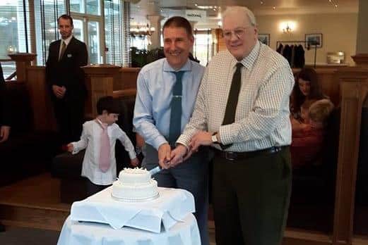 Colin and Frank cutting the cake on their wedding day.