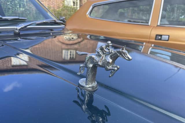 The woman jockey emblem on the bonnet of the car was presented to the Princess Royal after she competed in the 1976 Montreal Olympic Games.