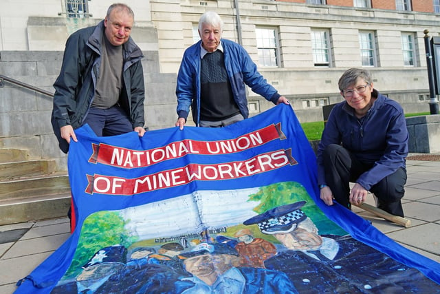 Colin Hampton, coordinator of Derbyshire Unemployed Workers Centre, with ex Bolsover miner Dennis Clayton and artist Kathryn Webley with the banner she painted.