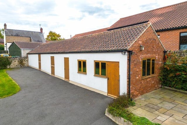 Outbuildings on the plot include this former stable block, which has been refurbished and now contains four versatile rooms that could make short-term holiday lets.