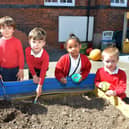 Reception class at Heath Primary planting seeds for Earth day.