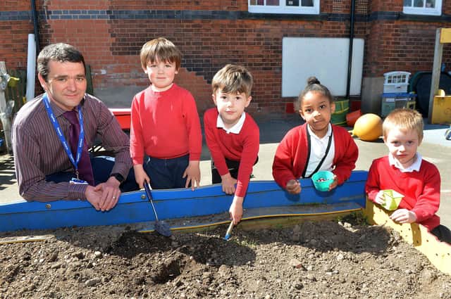 Reception class at Heath Primary planting seeds for Earth day.