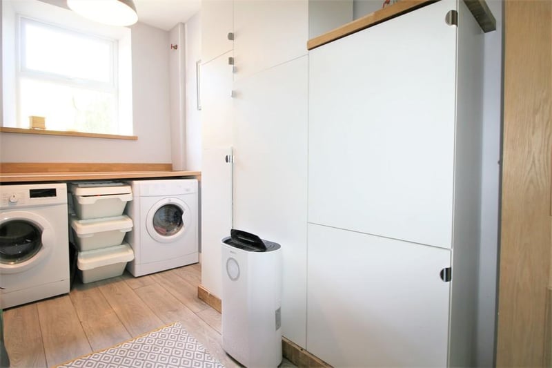 Great storage under the stairs, built-in cupboards and space for a washing machine and dryer.