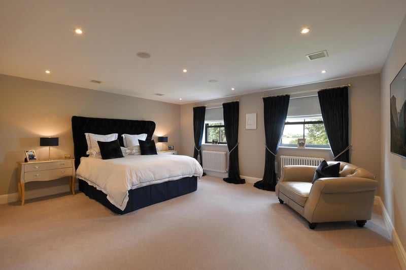 A luxurious master bedroom featuring a walk-in wardrobe, dressing room and a stylish en-suite bathroom.