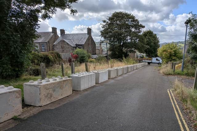 A plan for the protected access was submitted to the court and approved, with the blocks to not sit within the road carriageway, but along its borders. This is not what has been installed. Image from Eddie Bisknell.