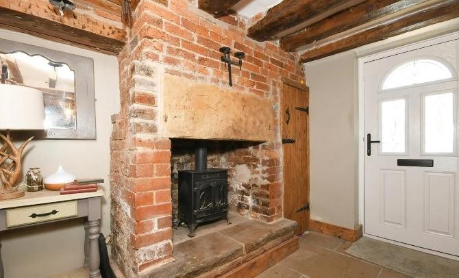 The entrance hall has a fireplace and is laid with limestone tile which extends throughout the ground floor accommodation.