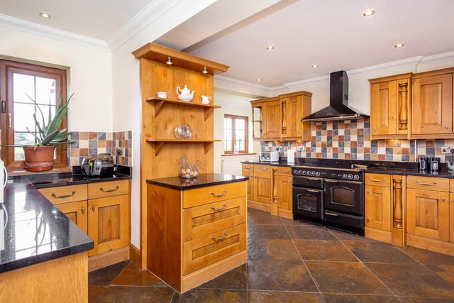This large well-equipped kitchen features "quality fitted units", appliances with solid granite worktop.