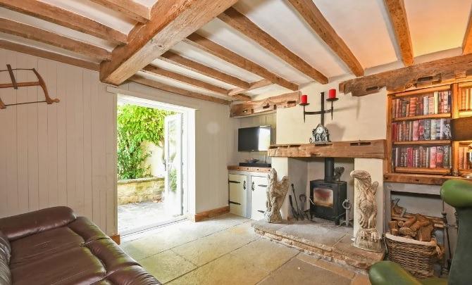 How about unwinding in this beautiful room with its original  oak timber beams on a low level ceiling, multi-fuel burner on a raised fireplace and  French doors opening onto a garden terrace?