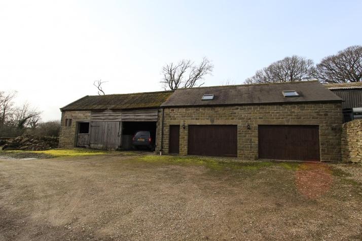 Including two pairs of wooden doors, electric, power and light, all offering excellent storage. There is additional hobby or workshop space at first floor level where there are Velux roof lights to the front, mullioned window to the gable wall and a central stud partition. Adjoining the garage is a range of stables suitable for livestock or implement storage. The building is of stone construction with a timber front elevation.