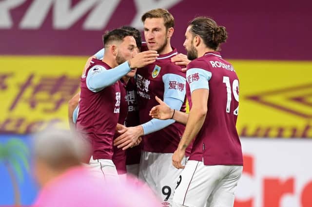 Chris Wood celebrates with teammates after scoring the opening goal of the English Premier League football match between Burnley and Crystal Palace. (Photo by MICHAEL REGAN/POOL/AFP via Getty Images)