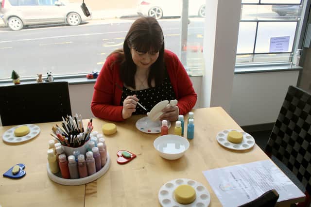 Carla painting pottery