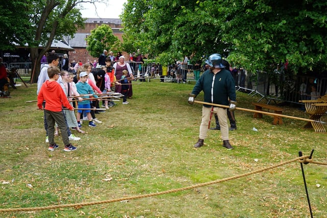 Medieval army recruits training with pikes.