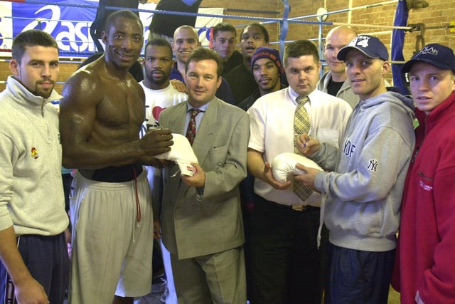 Johnny Nelson and Ryan Rhodes pictured signing Boxing gloves with sponsors Peter Eyre and Michael Smith sponsores back in 2001