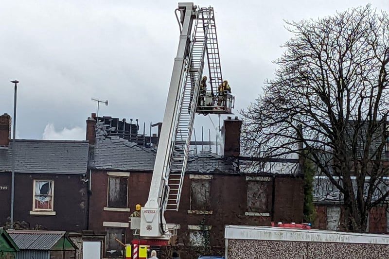 The roof of the derelict house has been damaged by flames.